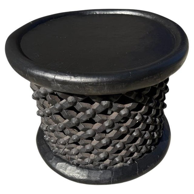 African coffee table or side table hand carved from one piece of wood from Cameroon, featuring a lattice pattern. We have...