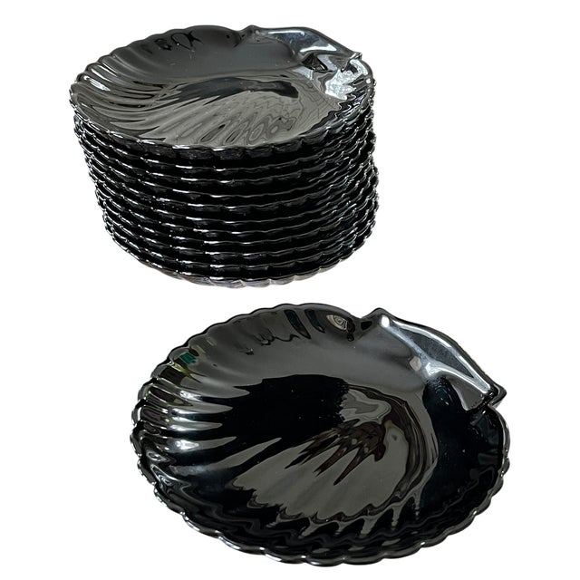 Bring a touch of French Riviera glamour to your table with this set of twelve vintage Arcoroc France Coquillage dishes...