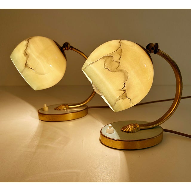 y Art deco table lamps featuring an oval brass base with light blue and turquoise enamel highlight, brass craddle with leo...
