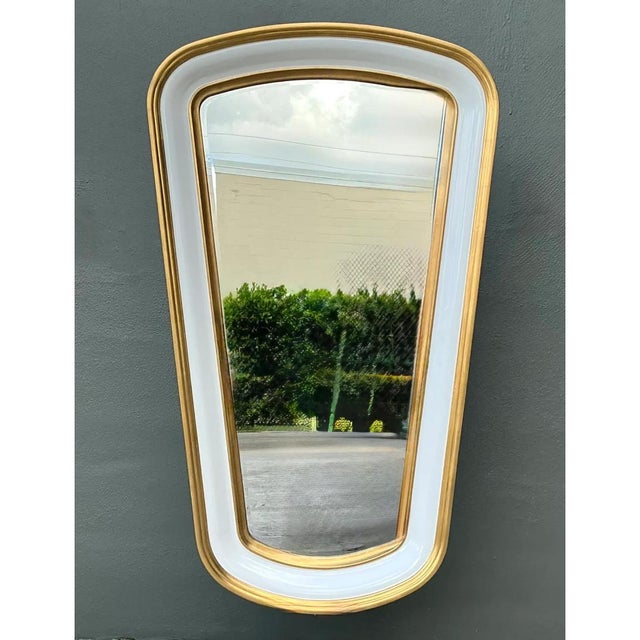 This set of two vintage mirrors presents a bold, sculptural trapezoid silhouette, with a broad, softly rounded top that...