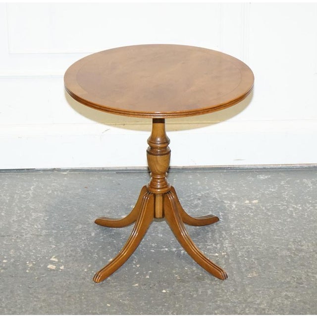 A charming vintage yew wood side table, perfect for use as an end table, wine table, or lamp stand. Crafted in warm,...