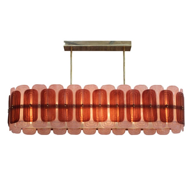 Elegant suspension lamp handcrafted in Murano, Italy. This exquisite lighting piece features a gold-finished metal...