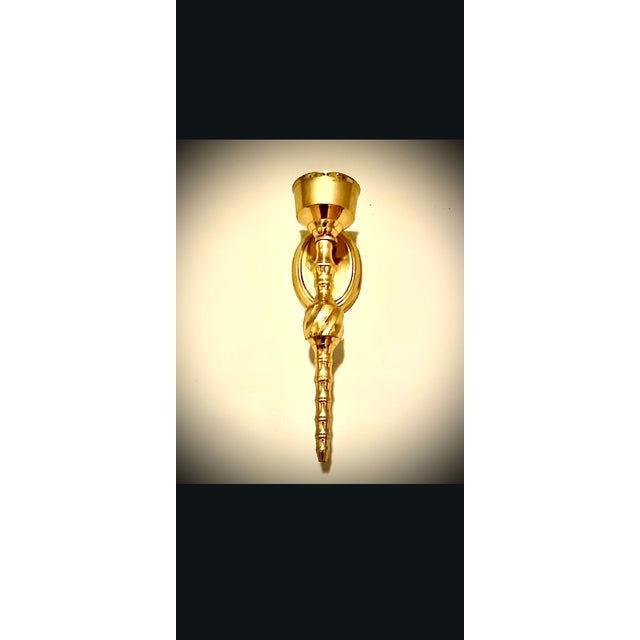 This item is a vintage brass wall sconce candle holder, likely in a Hollywood Regency or style. hese vintage lidded bowls...