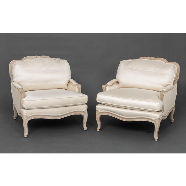 Pair of Louis XV Style White Fabric Upholstered Cerused Wood Bergeres, with Interior Crafts labels beneath cushions....