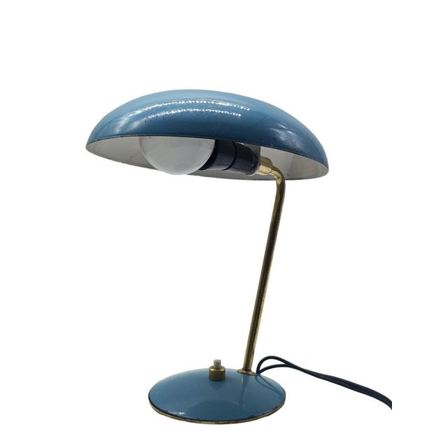 A charming, small Italian table lamp with a blue shade and base, featuring brass details. The blue enamel accentuates the...