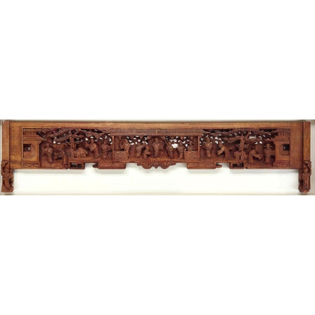 A Chinese carved wood door lintel presented in a deep shadow frame circa late Qing dynasty (late 19th century). The piece...