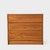 A compact teak three-drawer chest with expressive flowing grain, full-width integrated pulls and a recessed base. Its...