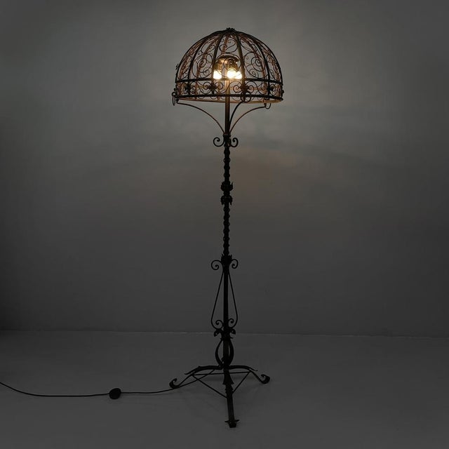 Italian Art Deco floor lamp in iron with curls and flowers decoration, 1930s Floor lamp entirely made of iron. The dome-...