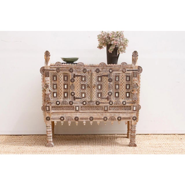 Envision a cabinet born from the heart of India, a piece that once graced a grand home, perhaps a haveli or a royal...