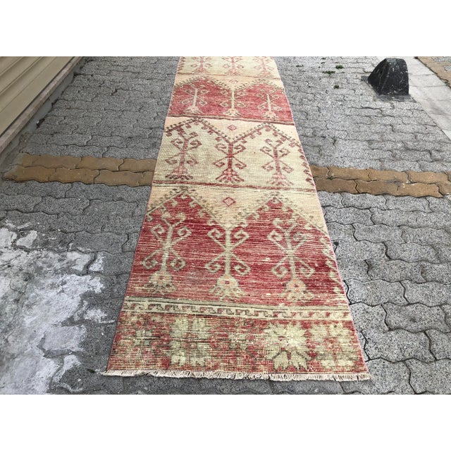 This is a vintage Turkish Oushak rug from the 1960s. The piece was hand-knotted.