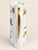 This is a white ceramic pitcher featuring a hand-painted floral design with red, yellow, blue, and green flowers and...