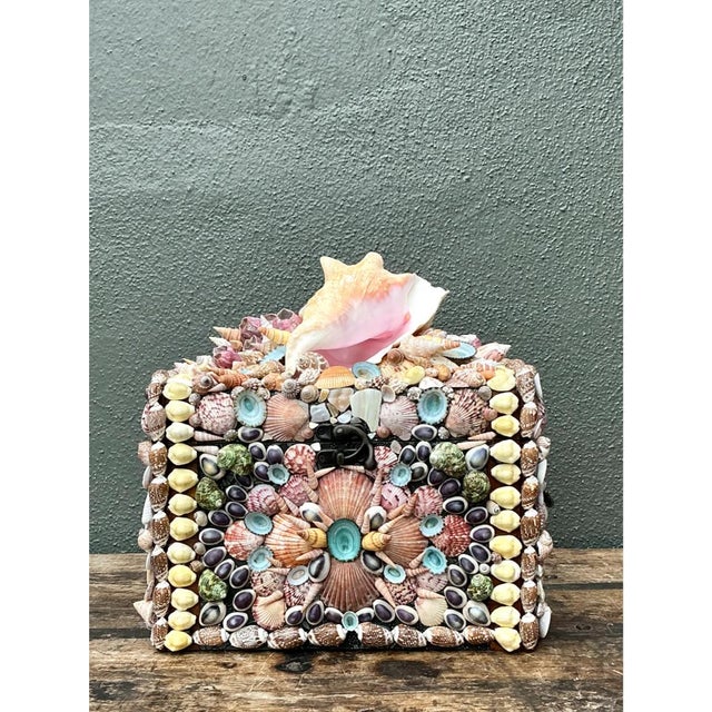 This vintage decorative box transforms a sturdy wooden case into a dazzling sailor's valentine-style treasure, its every...