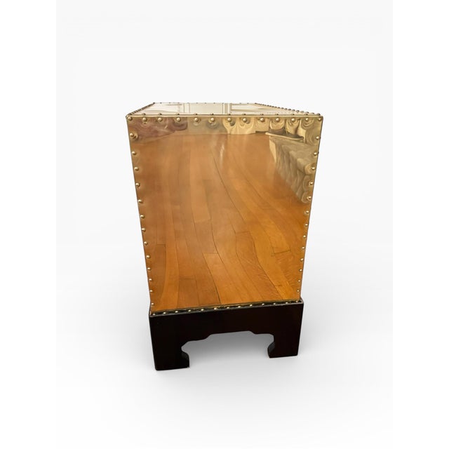 This brass-clad three-drawer chest is attributed to Sarreid Ltd. and reflects the company’s signature campaign-inspired...