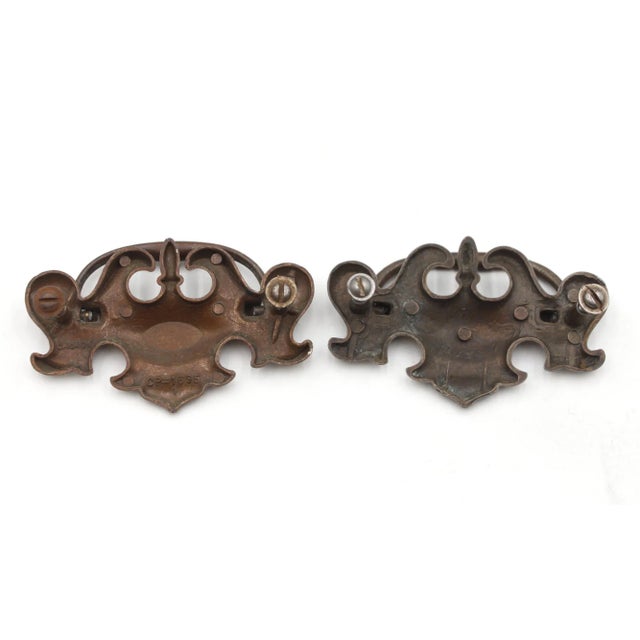 Vintage Traditional brass bail drawer pulls with a darkened brass patina. Inscribed CP-1695, Canada. Mounting screws are...