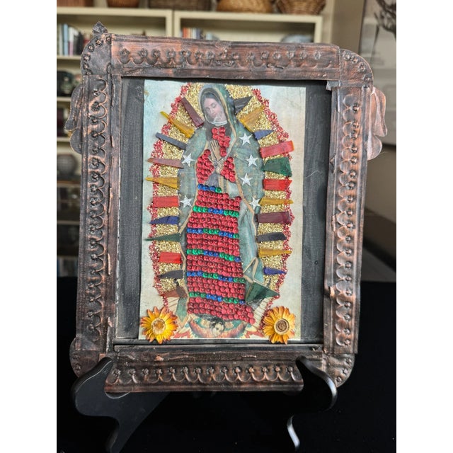 This vintage Mexican nicho shrine is a mixed-media devotional work assembled from metal, paper, and applied decorative...