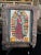 This vintage Mexican nicho shrine is a mixed-media devotional work assembled from metal, paper, and applied decorative...