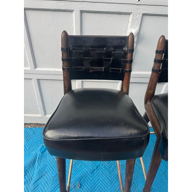 Pair of Mid-Century Modern Chairmasters Black Leather Webbed Bar Stools, circa 1950s A handsome pair of original mid-...