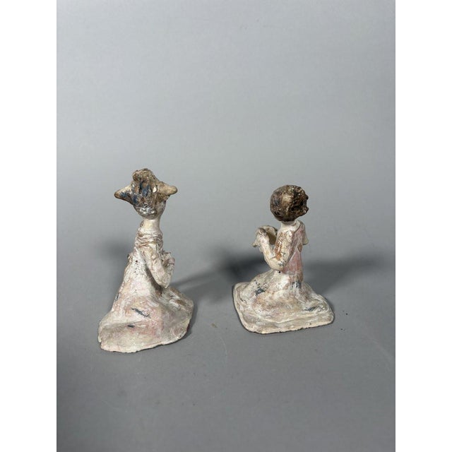 Pair of Mingqi Sculptures, China, Tang Dynasty (618-907). Terracotta sculptures painted with a white and red slip. Depicts...