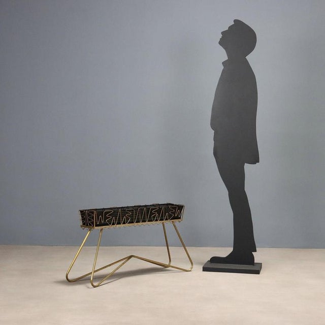 Planter in brass and enamelled metal sheet. This piece is attributed to the mentioned designer/maker. It has no...