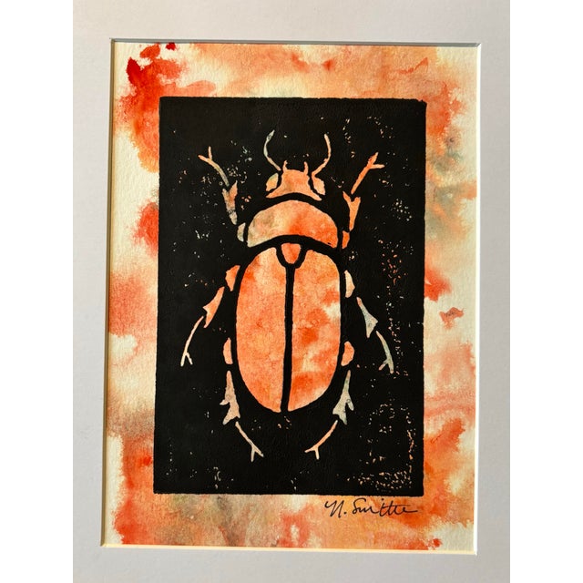 An original hand-carved block linocut featuring a detailed beetle motif, individually printed with black ink and finished...