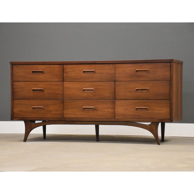 A mid century modern walnut dresser with a scratch resistant formica top by Johnson Carper. Circa 1960’s. Made in USA....