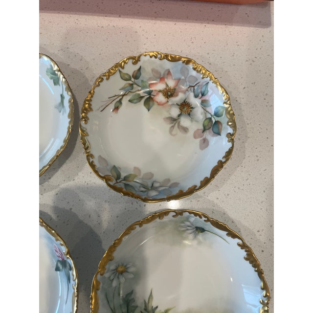 Hand painted and gilded set of six limoges dessert dishes in perfect condition with a different flower on each dish. made...