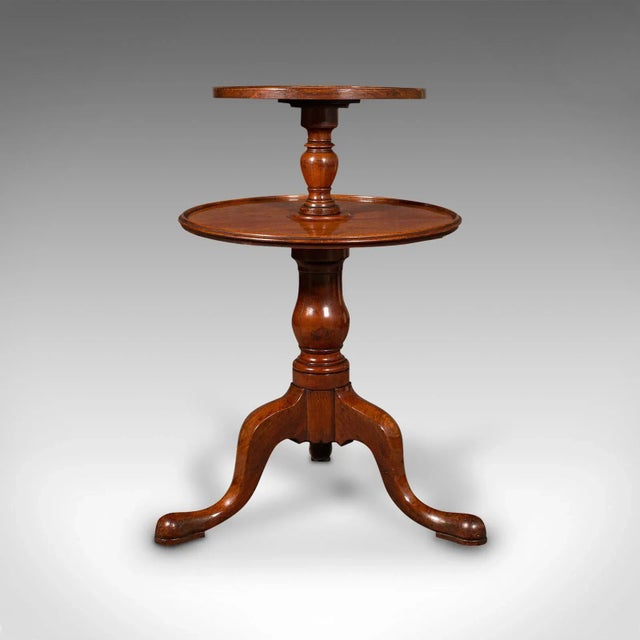 This is an antique country house dumb waiter. An English, mahogany 2-tier serving table, dating to the Georgian period,...