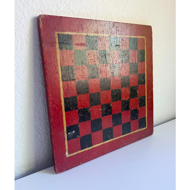 An authentic antique checkerboard from the late 19th to early 20th century. The piece is a classic example of early...