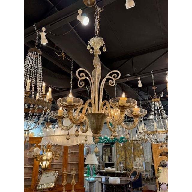 A Murano amber glass 6‑arm chandelier brings together the warmth of honey‑toned Venetian glass with the sculptural...