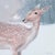 This artwork depicts a serene scene featuring a gentle deer in a winter landscape, surrounded by soft, muted tones that...