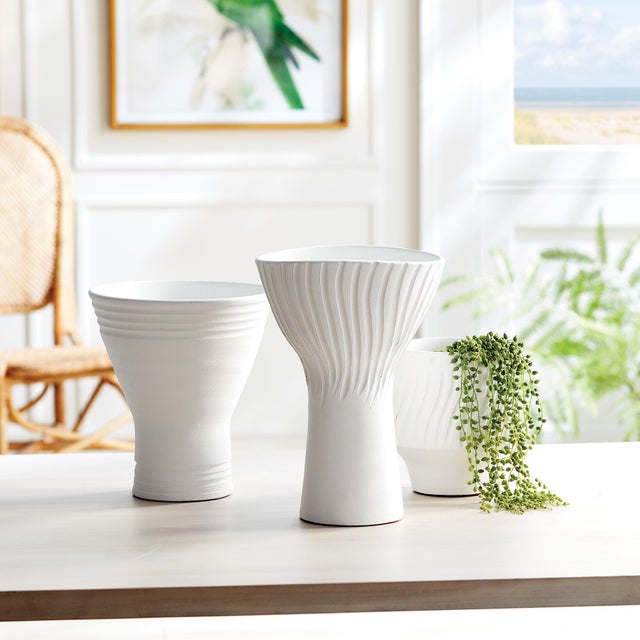 With a fluted shape and carved linear pattern around the body, this matteWhite vase is the definition of simplicity in...