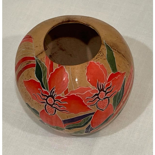This folk art vase was handcrafted in Malaysia. Very lightweight with vibrant colors.