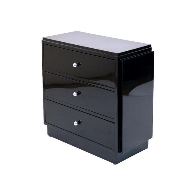 Dainty chest of drawers in black lacquer Art Deco. France around 1930. Three-drawer body with stepped sides standing on a...