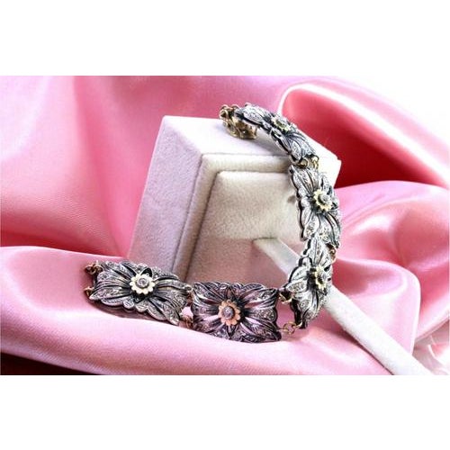 Gold and Silver Bracelet with Central Zirconias and Flower-Shaped Applications, in Very Good conditions. Designed 1980 to...