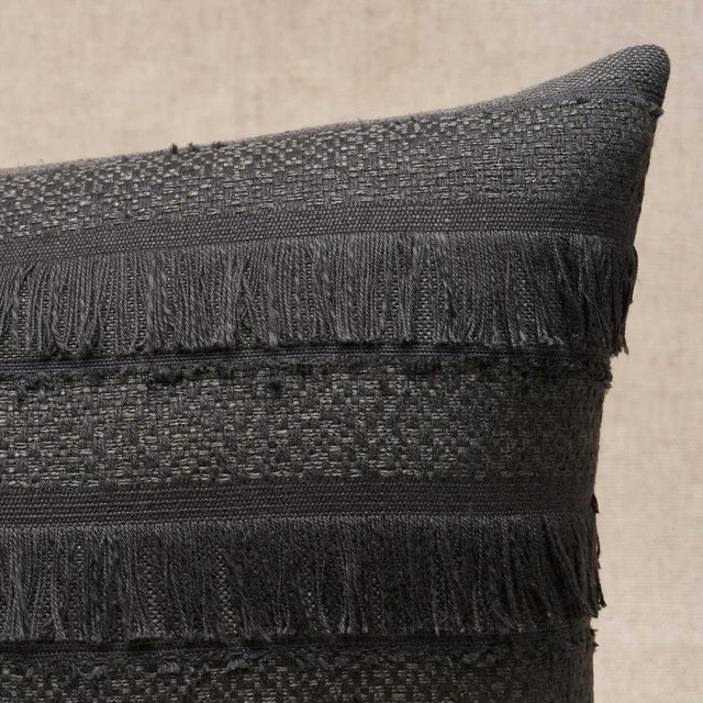 This pillow features Acadia with a knife edge finish. A horizontal fringed stripe, this pattern derives from a textile in...