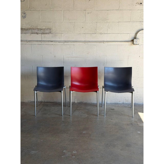 This set of 3 stacking chairs features contoured seats and space-saving functionality. Vintage 1990s. Designed by Philippe...
