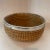 Handmade rustic coiled basket with metal band at the top. Measures 12" in diameter x 5" high. A lovely accent piece that...