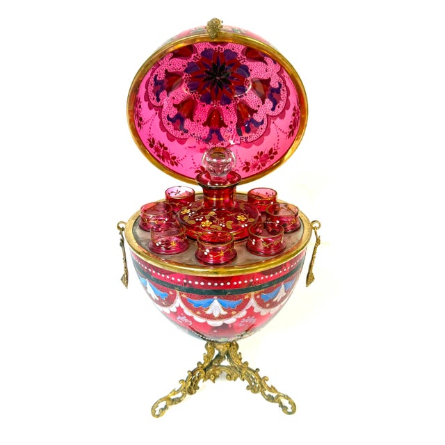 Magnificent Moser Cranberry Glass Imperial Egg-Form Tantalus Service, 1880s An extraordinary example of late 19th-century...