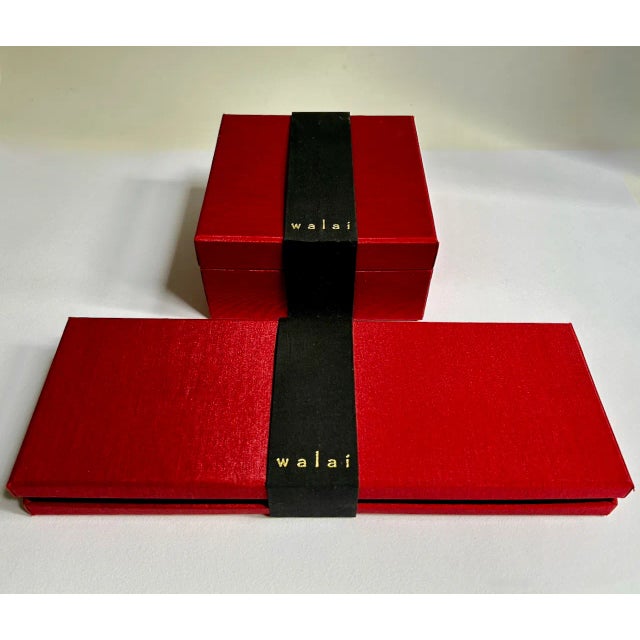 Boxed Set of Four Walai Orange accented Crimson Red Silk Folded Placemats and Napkins. Featuring boxed Black Silk backed...