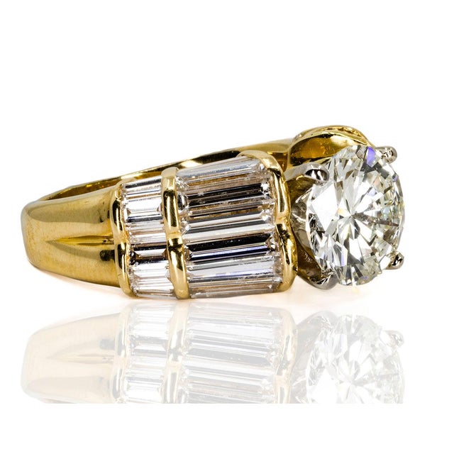 18k & Platinum ring sset with 2.45 carat GIA certified L color I1 clarity round brilliant and 8 bauette diaamonds weighing...