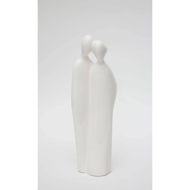 This vintage tall sculpture and or object of an abstract couple; man and woman is white to off-white porcelain by...