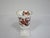 An elegant Aynsley bone china stemmed vase made in England. It is decorated with an intricate design of a bird paradise...