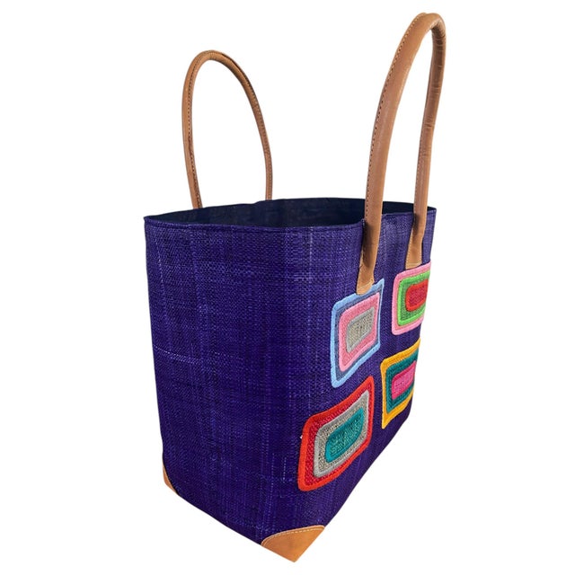 This hand made Sewn Embroidered large Raffia /leather Tote Bag from Madagascar showcases traditional raffia weaving with...