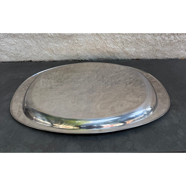 Alessi, Italy oval stainless steel tray. The manufacturer’s mark is stamped on the back of the tray.