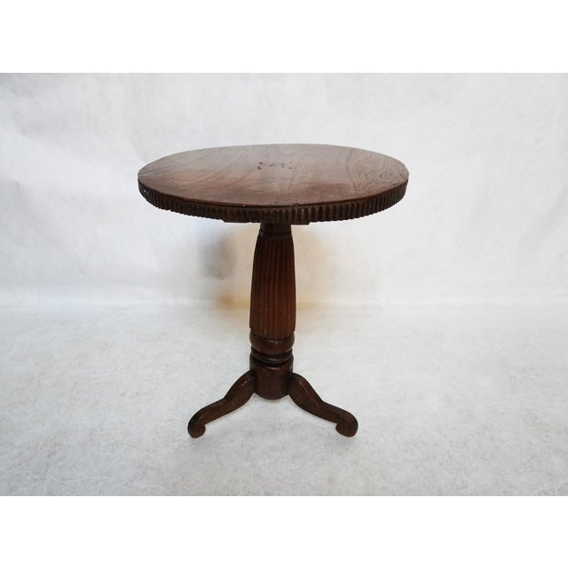 Antique Rustic Round Wood Pedestal Side Table Slightly irregular circular top with a fluted base and rim on the table. The...