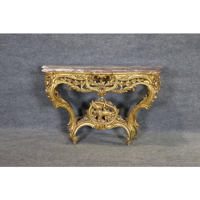 Measures: 33 1/2" h x 50 1/2" w x 16 1/4" d. It clings to the wall like something grown there — as though the house itself...