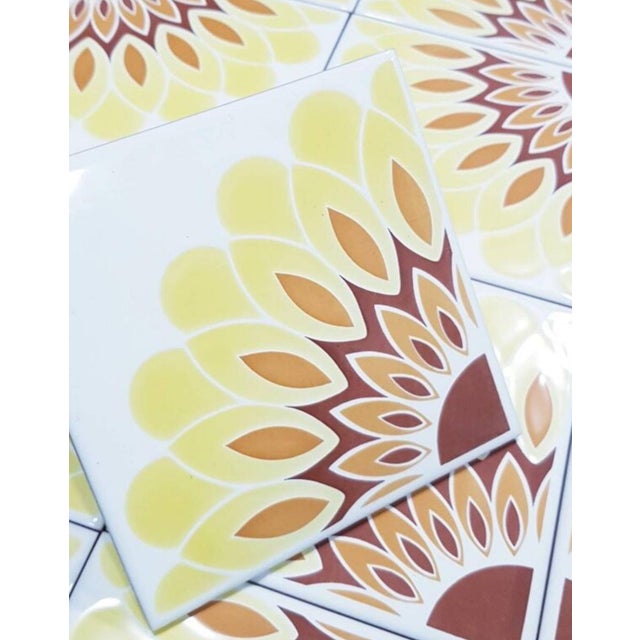 1970's Italian glazed wall tiles with a large starburst flower pattern, 15 x 15 cm per tile. 4 tiles create a complete...