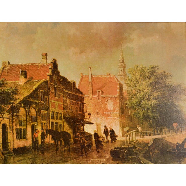 This charming litho print on board captures the essence of a quaint Dutch canal scene. The picturesque view depicts...