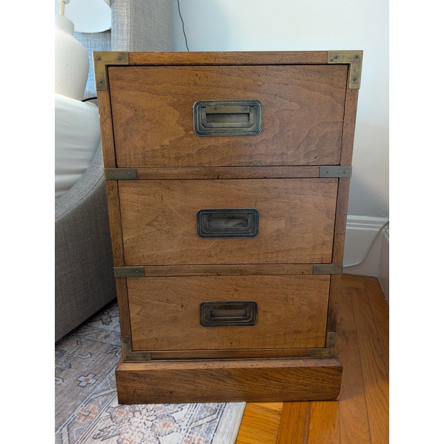 An elusive and highly sought-after pair of 1960s Campaign-style nightstands by Milling Road for Baker Furniture. These...