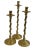 Trio of three brass twisted candlestick holders. This set is made from solid polished brass. The trio features a twisted...
